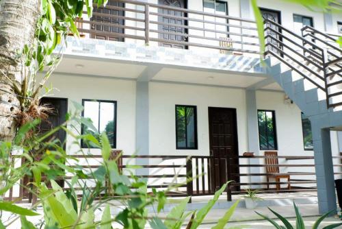 a house with a staircase in front of it at LMIRAMARS Tourist Inn in Itaytay