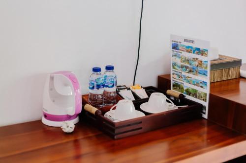 a tray with bottles of water on a wooden floor at The Lavana Jhonny Kibung Villas Lembongan in Nusa Lembongan