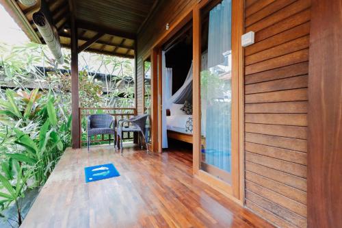 a porch of a house with a room with a bed at The Lavana Jhonny Kibung Villas Lembongan in Nusa Lembongan