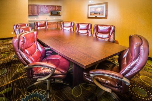 a conference room with a wooden table and leather chairs at Holiday Inn Express Hotel & Suites Gunnison by IHG in Gunnison