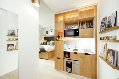 a kitchen with a sink and a microwave in a room at Wilde Aparthotels London Covent Garden in London