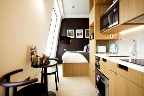 a small kitchen with a bed and a table in a room at Wilde Aparthotels London Covent Garden in London