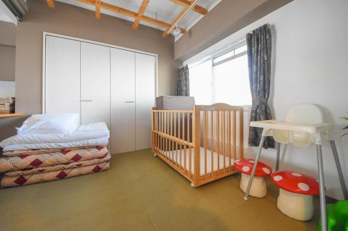 a baby bedroom with a crib and a window at Comfy Stay TDS in Nara