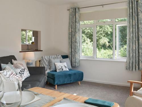 a living room with a couch and a window at The Duck House in Wool