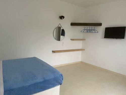a room with a bed and a tv on a wall at Sakas Residences in Karterados