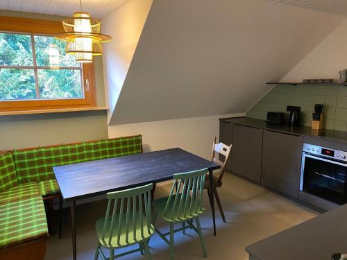 a kitchen with a table and chairs in a room at pop-up stuub feldberg in Feldberg