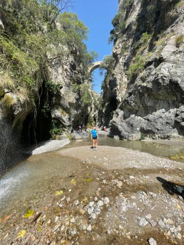 a man walking on the sand in a river at La Magara in Civita