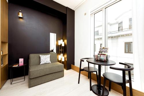 a living room with a chair and a table at Wilde Aparthotels London Covent Garden in London