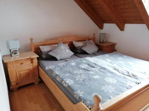 a bedroom with a bed with a blue comforter at Ferienwohnung Osserglück in Lohberg