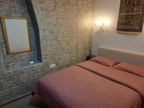 a hotel room with a bed and a mirror at Modern Residence in the Center of Trikala in Tríkala