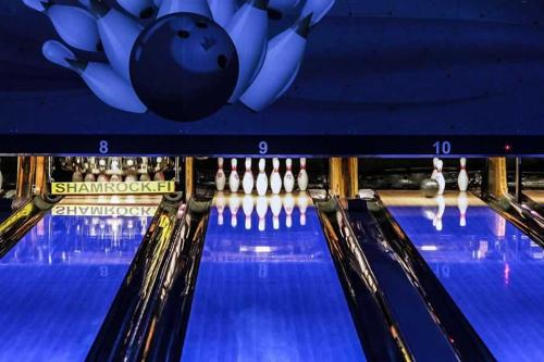 um grupo de pistas de bowling com uma bola na pista em Hotel Tikkurila em Vantaa