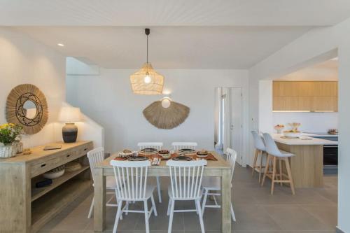 a kitchen and dining room with a table and chairs at Solasta Residence in Márpissa