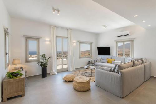 a living room with a couch and a tv at Solasta Residence in Márpissa