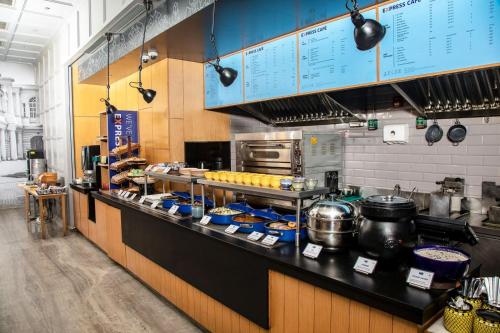 a kitchen with a counter with pots and pans at Holiday Inn Express Chennai OMR Thoraipakkam by IHG in Chennai