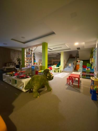 a room with a toy dog laying on the floor at Malkia Penzion in Orechová Potôň