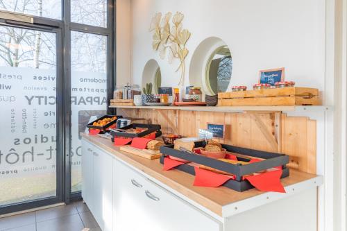 a counter with several boxes of food on it at Appart'City Classic Caen in Caen