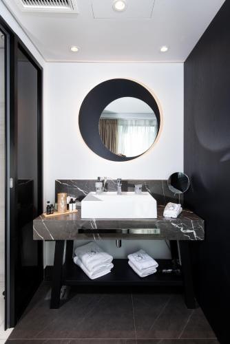 a bathroom with a sink and a mirror at S Hotel Boutique Thessaloniki in Thessaloniki