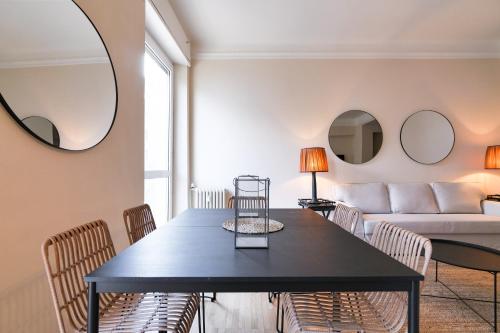a living room with a table and a couch at Luxury San Babila Apartment in Milan
