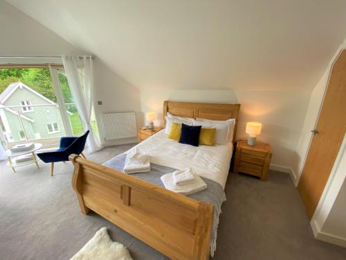 a bedroom with a large bed and a large window at Trewhiddle Villa 30 in St Austell