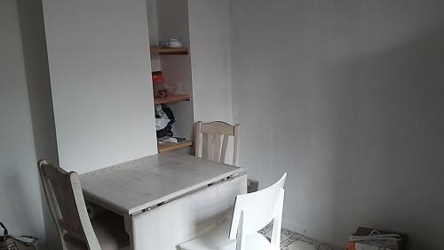 a table and two chairs in a room at Rundvejen Guest House in Aalborg