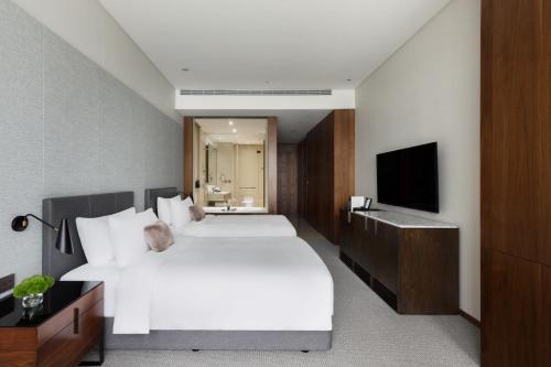 Postel nebo postele na pokoji v ubytování EPISODE Hsinchu, JdV by Hyatt Hotel