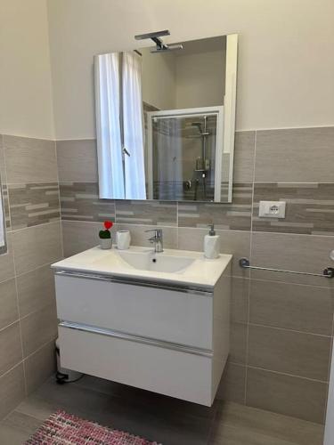a bathroom with a sink and a mirror at Appartamento Mirsie in Bologna