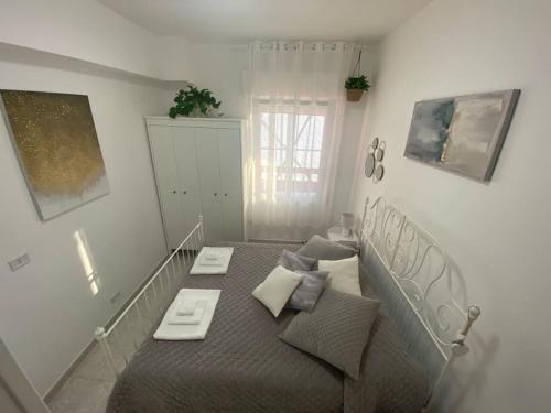 a bedroom with a bed with two tables on it at Appartamento Mirsie in Bologna