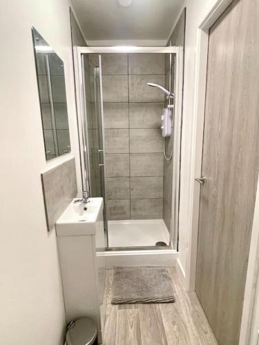 a bathroom with a shower and a toilet and a sink at 2.Superb Serviced Apartment - free on road parking in Birmingham