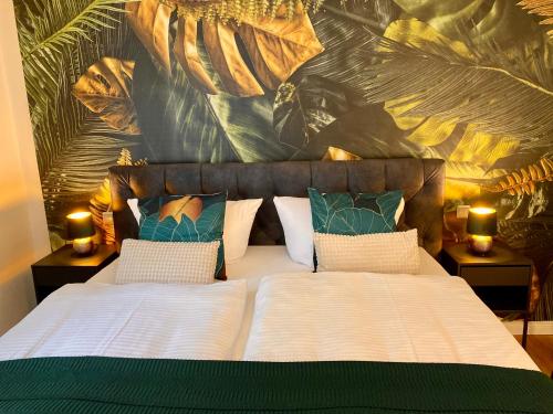 a bedroom with a large bed with two lamps on tables at Traumhaus Wernigerode mit Sauna und Kamin in Wernigerode