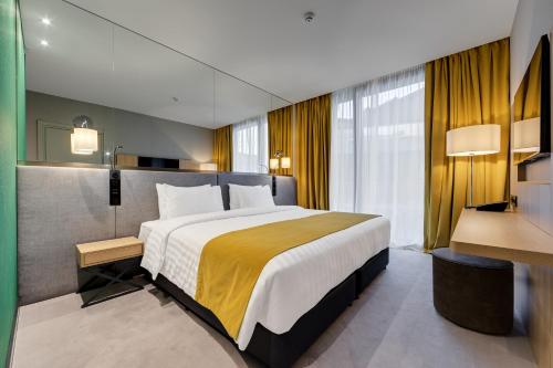 Una cama o camas en una habitación de Glarros OldTown