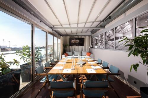 a large dining room with a long table and chairs at S Hotel Boutique Thessaloniki in Thessaloniki