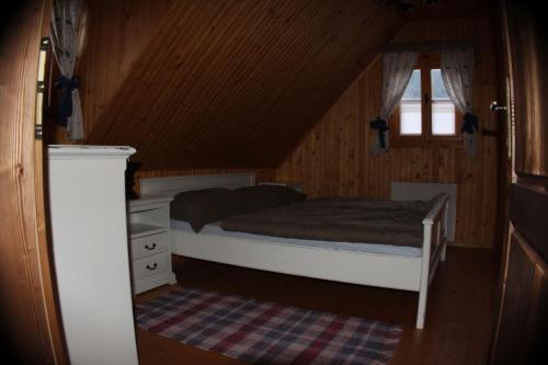 a small bedroom with a bed and a window at FAMILY RESORT ZÁZRIVÁ - Drevenica LIPA in Zázrivá