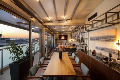 a restaurant with a table and chairs on a balcony at S Hotel Boutique Thessaloniki in Thessaloniki