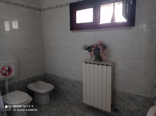 a bathroom with a toilet and a sink and a window at Don Pablo in Lecce
