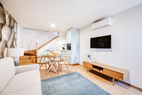 a living room with a couch and a table at Casa do Calhau - 1 bedroom apartment sleeps 4 in Câmara de Lobos