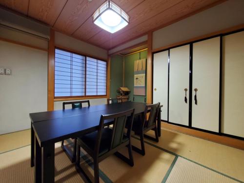 a dining room with a table and chairs at Oyado Sumire-so in Takayama