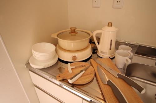 a kitchen counter with dishes and a pot on it at Mount Fuji Panorama Glamping in Fujikawaguchiko