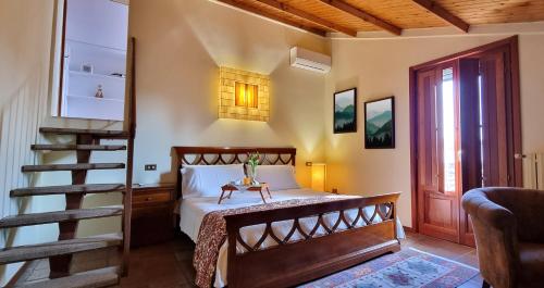 a bedroom with a bed with a wooden frame and a staircase at Al Parco in San Benedetto Po