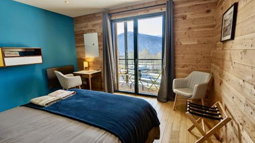 a bedroom with a bed and a large window at Balcons de Sorgeat - Chambres d'hôtes in Sorgeat