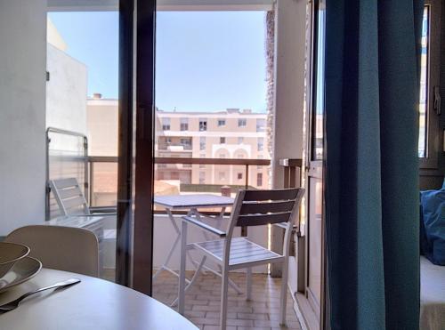 a room with a balcony with a table and chairs at Résidence Graziella Studio 308 in Juan-les-Pins