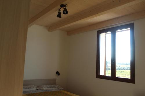 a room with two beds and a window at Agriturismo Mimosa in Rispescia
