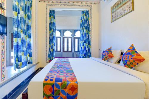 a bedroom with a large bed in a room at FabExpress Achrol Palace in Udaipur