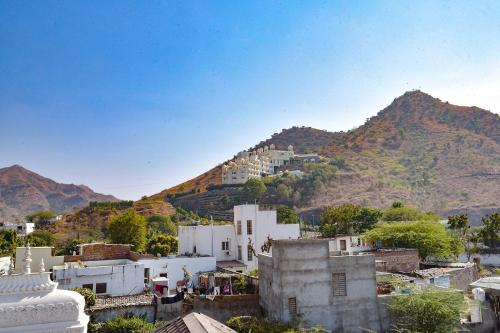 a view of a city with a mountain in the background at FabExpress Achrol Palace in Udaipur