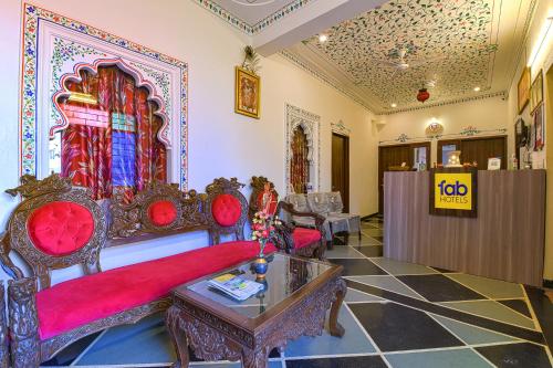a living room with a couch and a table at FabExpress Achrol Palace in Udaipur