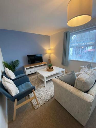 a living room with a couch and a chair at Eremue Court Hideaway Yarmouth IOW in Yarmouth
