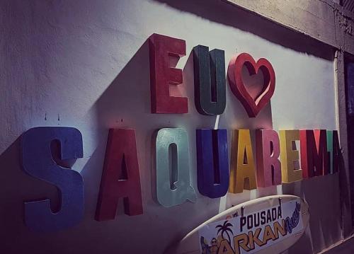 a sign on a wall that says eat a cabbage at POUSADA ARKAN BEACH in Saquarema