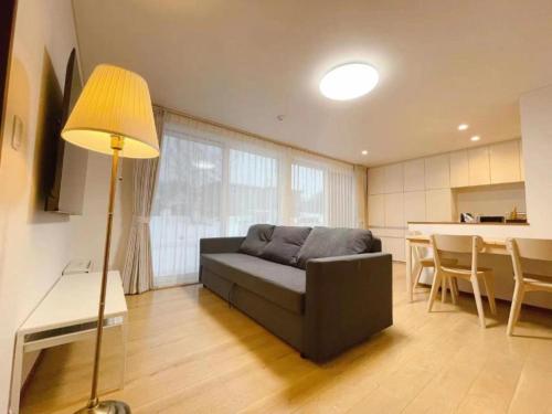 a living room with a couch and a table at Niseko White Villas YUNOSATO in Rankoshi