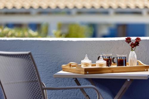 a tray of drinks on a table next to a chair at Vasia Ormos Hotel (Adults Only) in Agios Nikolaos
