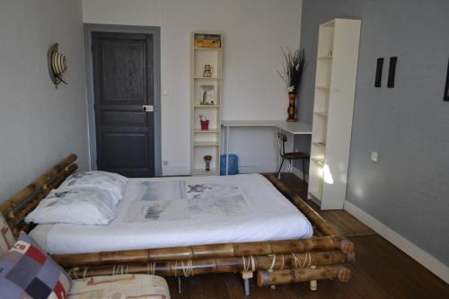 a bedroom with a large bed in a room at Belle chambre d'hôte pour 2 à 4 PERSONNES in Chef-Boutonne