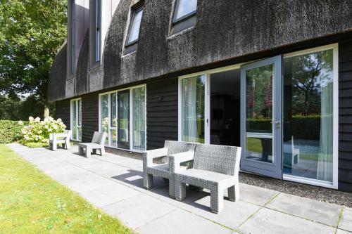 a group of benches sitting outside of a building at Hotel De Roode Schuur in Nijkerk